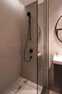 a shower with a glass door in a bathroom at Waves - Comfort and Style in a 21st-Floor Studio With View in Dubai