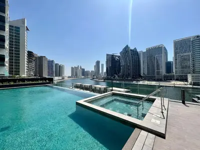 a swimming pool on top of a building with a city at Waves - Comfort and Style in a 21st-Floor Studio With View in Dubai