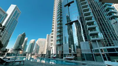 a large building with a pool in the middle of a city at SmartStay at Opera Grand - Stunning Burj Khalifa Views - Brand New Luxury Residences in Dubai