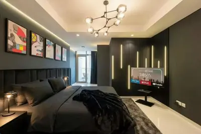 a bedroom with a bed and a tv on a wall at Premium 2 BDR Burj Khalifa Infinity Pool View in Dubai