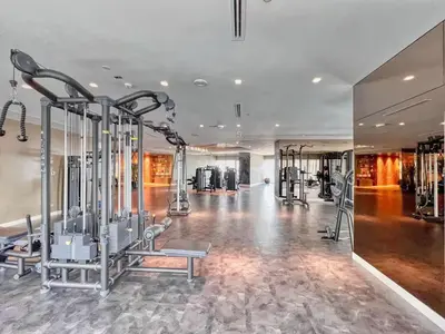 a gym with treadmills and machines in a room at Premium 2 BDR Burj Khalifa Infinity Pool View in Dubai