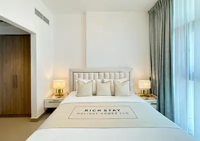 a bedroom with a white bed with a sign on it at Extraordinary 2BR in Prive Residence, Dubai Hills in Dubai