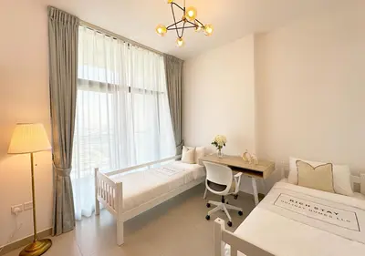 a bedroom with two beds and a desk and a window at Extraordinary 2BR in Prive Residence, Dubai Hills in Dubai