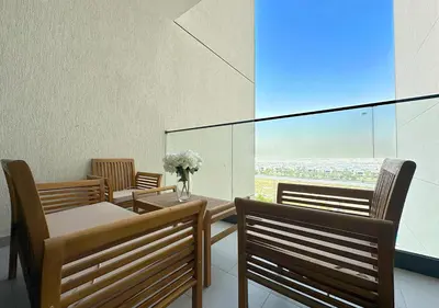 a dining room with three chairs and a table with flowers at Extraordinary 2BR in Prive Residence, Dubai Hills in Dubai