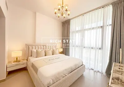 a bedroom with a large bed and a large window at Extraordinary 2BR in Prive Residence, Dubai Hills in Dubai