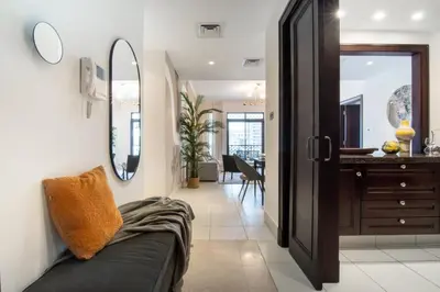 a living room with a couch and a mirror at The Smart Concierge - Reehan 6 in Dubai