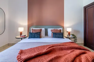 a bedroom with a large bed with two lamps at The Smart Concierge - Reehan 6 in Dubai