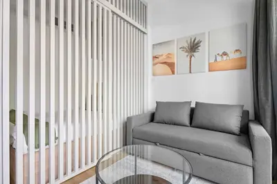 a living room with a couch and a glass table at Bright Downtown Dubai Studio by Mall, Burj Khalifa & Fountains in Dubai
