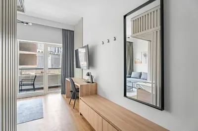 a bedroom with a mirror and a bed and a desk at Bright Downtown Dubai Studio by Mall, Burj Khalifa & Fountains in Dubai