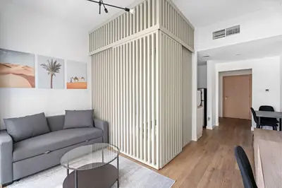 a living room with a couch and a table at New Design Studio next to Burj Khalifa, Mall & Dubai Fountain in Dubai