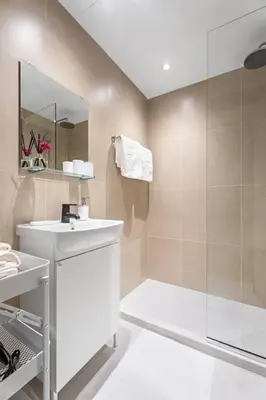 a bathroom with a white sink and a shower at New Design Studio next to Burj Khalifa, Mall & Dubai Fountain in Dubai