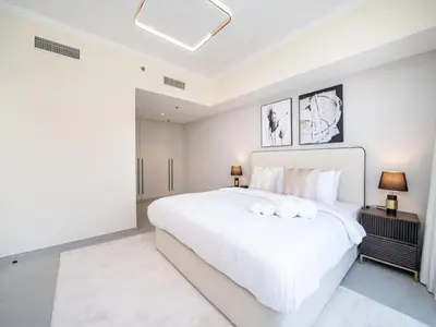 a large white bedroom with a large white bed at Stylish Upgraded 1 Bedroom Marina Escape in Dubai
