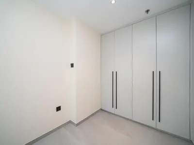 a room with white cabinets and a white wall at Stylish Upgraded 1 Bedroom Marina Escape in Dubai