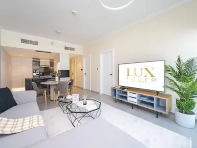 a living room with a couch and a tv in it at Stylish Upgraded 1 Bedroom Marina Escape in Dubai