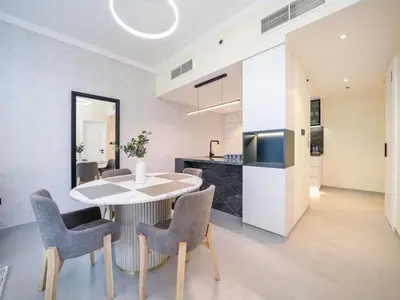 a kitchen and dining room with a table and chairs at Stylish Upgraded 1 Bedroom Marina Escape in Dubai
