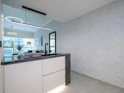 a kitchen with a white counter and a sink at Stylish Upgraded 1 Bedroom Marina Escape in Dubai