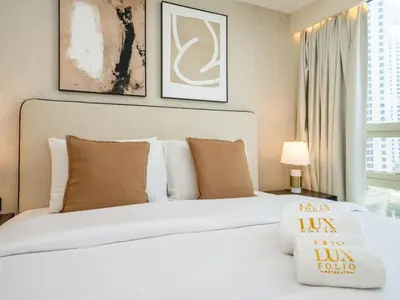 a bedroom with a large white bed with pillows at Stylish Upgraded 1 Bedroom Marina Escape in Dubai