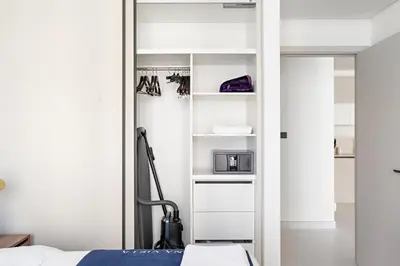 a bedroom with a closet with a bed and a mirror at Silkhaus Sea View 1BDR Exclusive Tower Beach in Dubai