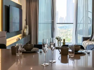 a living room with a table with wine glasses on it at High Floor Burj Khalifa View 1BR - Business Bay in Dubai