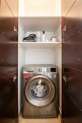 a washer and dryer in a small room at Spacious 2BR in Downtown in High Floor in Dubai