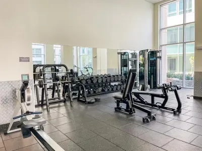 a gym with rows of treadmills and machines at Spacious 2BR in Downtown in High Floor in Dubai
