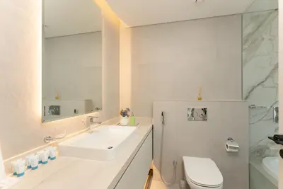 a bathroom with a sink and a toilet and a mirror at Condor Marina Star, Dubai Marina by SIMPLY COMFORT in Dubai