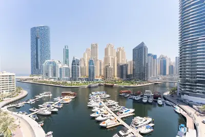 a group of boats docked in a harbor in a city at Condor Marina Star, Dubai Marina by SIMPLY COMFORT in Dubai