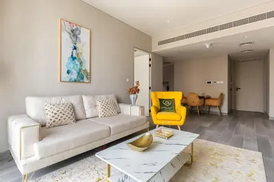 a living room with a couch and a yellow chair at Condor Marina Star, Dubai Marina by SIMPLY COMFORT in Dubai