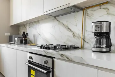 a kitchen with a stove and a coffee maker on the counter at Condor Marina Star, Dubai Marina by SIMPLY COMFORT in Dubai
