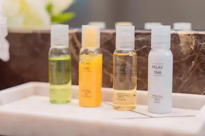 three bottles of essential oils sitting on a sink at Prime Retreats - Sparkle Tower Marina in Dubai