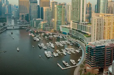 a group of boats docked in a harbor in a city at Prime Retreats - Sparkle Tower Marina in Dubai