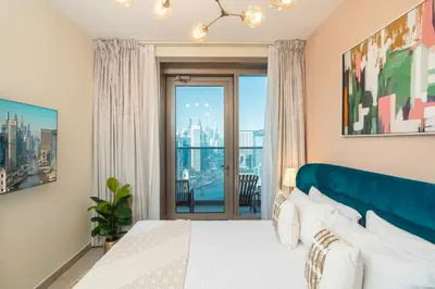 a bedroom with a bed and a large window at Prime Retreats - Sparkle Tower Marina in Dubai