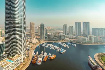 an aerial view of a city with boats in a harbor at Prime Retreats - Sparkle Tower Marina in Dubai