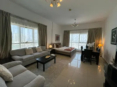 a living room with a couch and a table at Ashri HH, Studio in Dana Tower in Dubai
