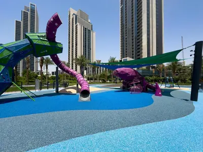 a playground with a purple and green roller coaster at Globalstay Creek Horizon Modern Apartments in Dubai