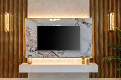 a flat screen tv on a wall with a marble wall at Globalstay Creek Horizon Modern Apartments in Dubai