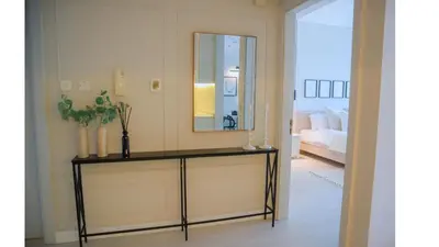 a room with a table with a mirror and a bed at Spacious 1BR, Pool, Gym, Near Dining & Shops in Dubai
