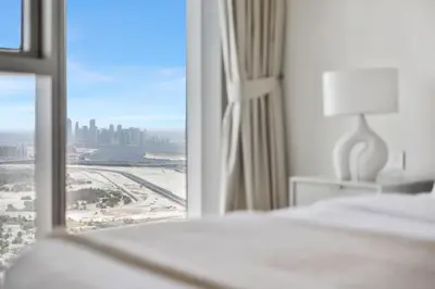 a bedroom with a window with a view of the city at 1BR with Park & Downtown Views plus Dubai Frame in Dubai