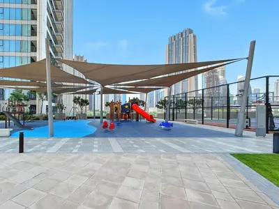 a playground with a canopy and a play area with a slide at 1BR with Park & Downtown Views plus Dubai Frame in Dubai