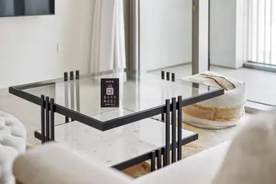a glass coffee table in a living room at 1BR with Park & Downtown Views plus Dubai Frame in Dubai
