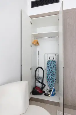a room with a closet with a vacuum cleaner at Shining studio in Laya Heights in Dubai