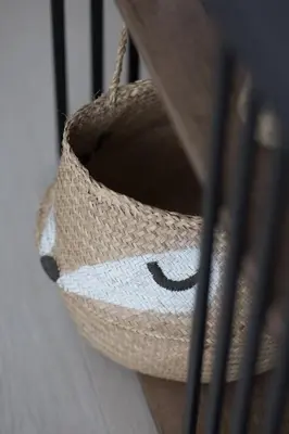 a straw basket sitting on a wooden shelf at Shining studio in Laya Heights in Dubai