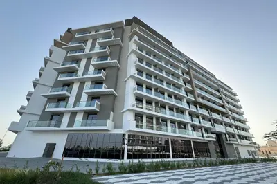 a large white building with balconies at Shining studio in Laya Heights in Dubai