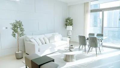 a white living room with a white couch and a table at New Elegance at Burj Crown downtown Balcony & View in Dubai