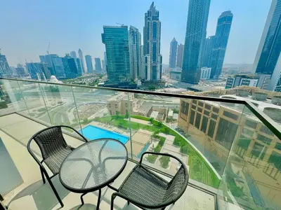 a balcony with two chairs and a table on a building at New Elegance at Burj Crown downtown Balcony & View in Dubai