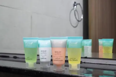 a group of four bottles of lotion on a counter at Peacefull Studio - Arjan in Dubai