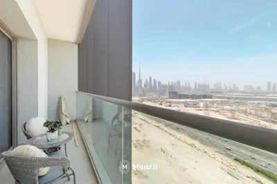 a balcony with a view of a city at Manzil - 1BR Apartment in Sobha Hartland with City Views in Dubai