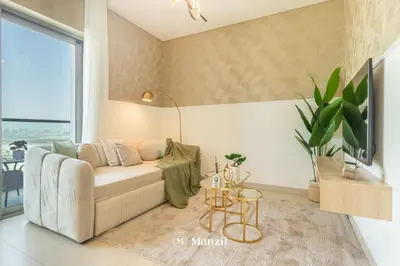 a living room with a couch and a table at Manzil - 1BR Apartment in Sobha Hartland with City Views in Dubai