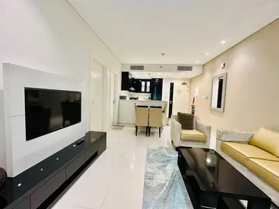 a living room with a large flat screen tv at 5 Star Hotel Residence Apartment- Walking to Downtown Dubai Mall in Dubai