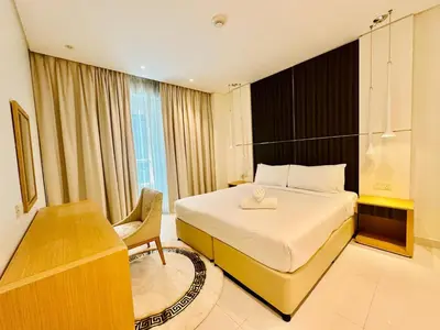 a hotel room with a bed and a chair at 5 Star Hotel Residence Apartment- Walking to Downtown Dubai Mall in Dubai